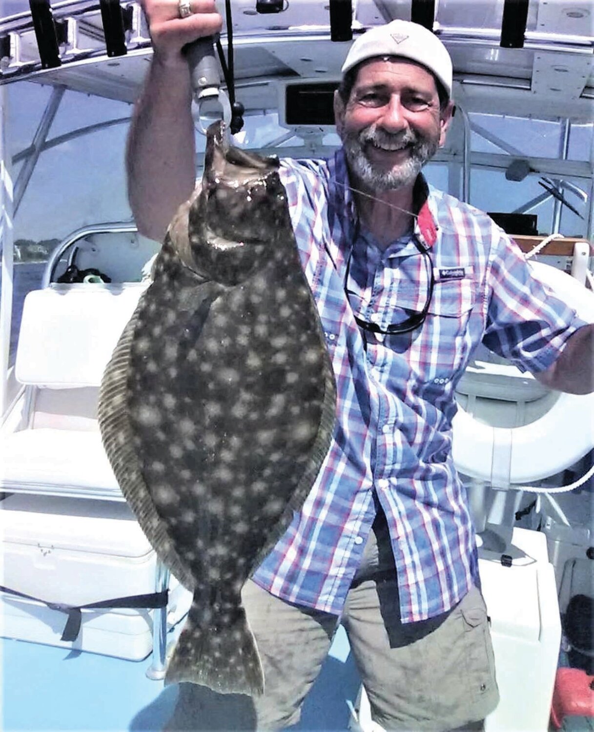 DOG DAYS OF SUMMER: Capt. Dave Monti with a summer flounder (fluke) caught during the dog days of summer at Austin Hollow, a 70’ underwater valley on the west side of Beavertail, Jamestown. (Submitted photos)